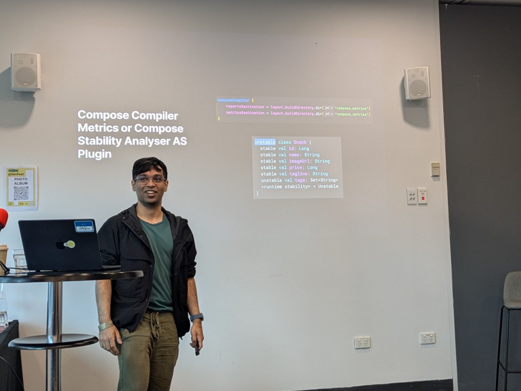 A speaker presenting at a conference, discussing Compose Compiler Metrics or Compose Stability Analyses as a Plugin, with a code snippet displayed on a screen in the background.